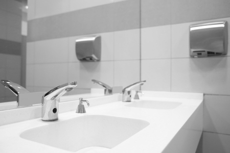 Modern sinks with mirror in public toiletの写真素材