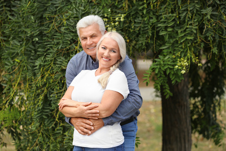 Mature couple together in parkの写真素材
