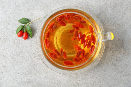 Cup with goji tea on tableの写真素材
