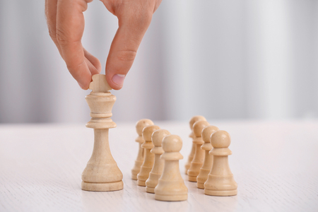 Young man with chess at tableの写真素材