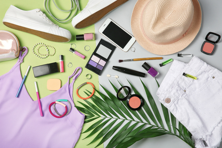 Composition with trendy clothes and tropical leaves on color backgroundの写真素材