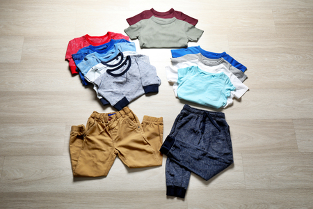 Collection of child's clothing on wooden backgroundの写真素材