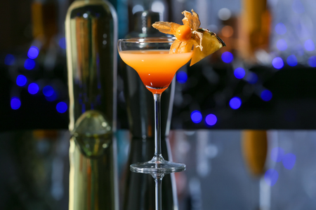 Glass with tasty exotic cocktail on tableの写真素材