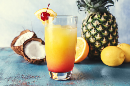 Glass with tasty exotic cocktail on table