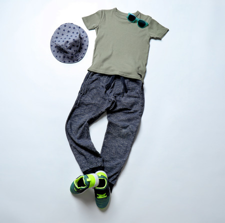 Child's clothes and sneakers on white backgroundの写真素材