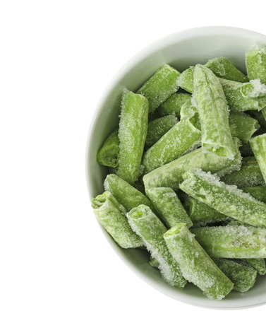 Bowl with frozen green beans on white background