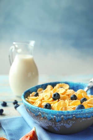 Dish with cornflakes and milk on tableの写真素材