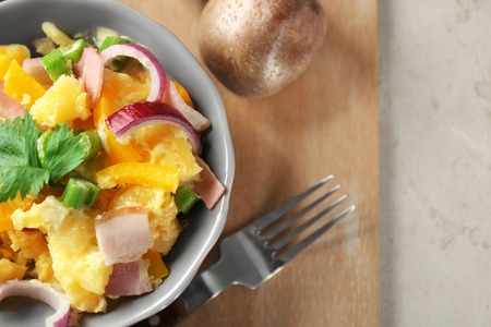 Bowl with delicious potato salad on table, closeupの写真素材