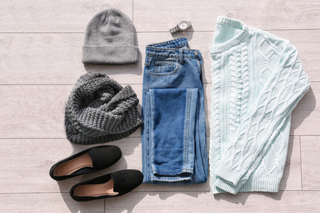 Set of stylish female clothes and accessories on wooden floorの写真素材