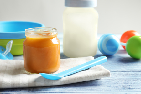 Composition with jar of healthy baby food on wooden tableの写真素材