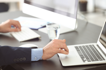 Manager working with laptop in officeの写真素材