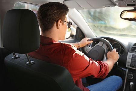 Young man on driver seat of car