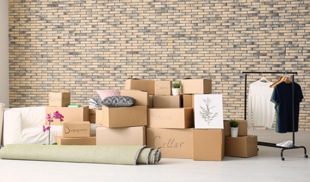 Carton boxes with stuff in room. Moving house conceptの写真素材