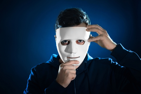 Hacker in mask on dark backgroundの写真素材