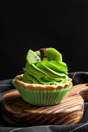 Wooden board with tasty cake on tableの写真素材