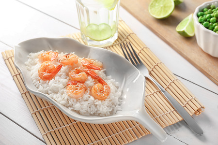Plate with delicious shrimp fried rice on tableの写真素材