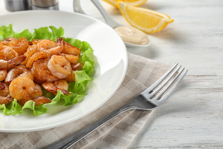 Plate with fresh tasty shrimp basket on tableの写真素材