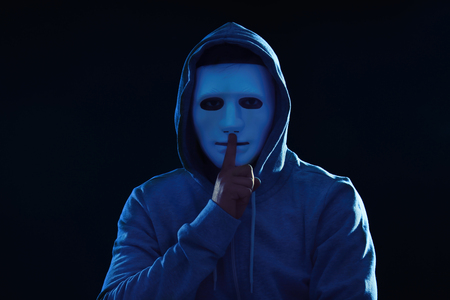Hacker in mask on dark backgroundの写真素材