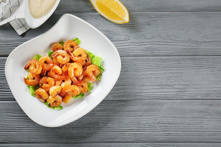 Plate with fresh tasty shrimp basket on tableの写真素材