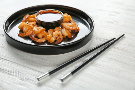 Plate with fresh tasty shrimp basket and sauce on tableの写真素材