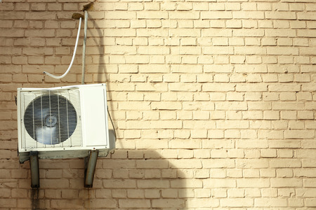 Air conditioner on wall of building outdoorsの写真素材