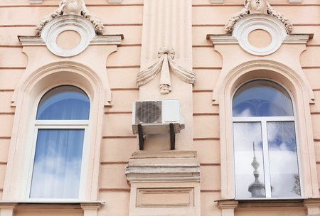 Air conditioner on wall of building outdoors