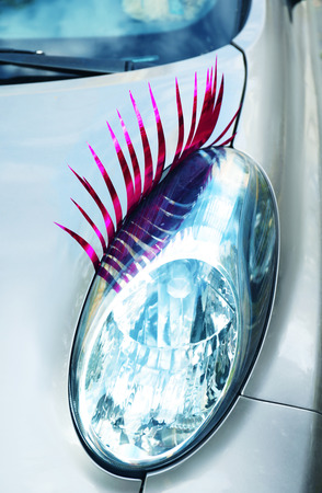 Car with eyelashes on headlight, closeupの写真素材