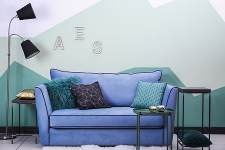 Comfortable sofa on color wall backgroundの写真素材