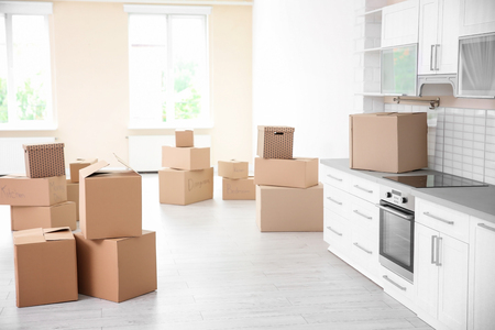 Cardboard boxes in kitchen of new apartmentの写真素材