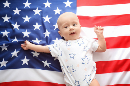 Cute baby on American flag backgroundの写真素材