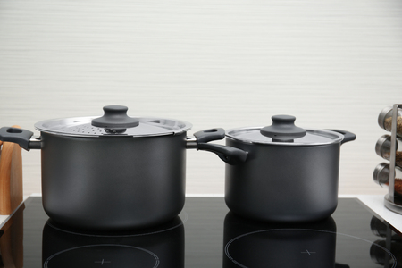 Stewpans on electric stove in kitchenの写真素材