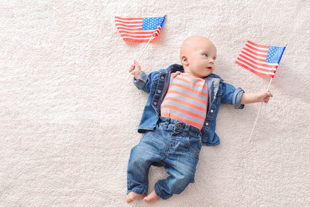 Cute baby with American flags on light backgroundの写真素材