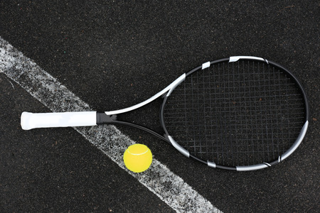 Tennis racket and ball on court