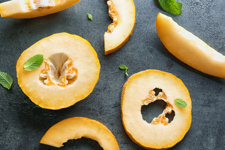 Yummy cut melon on grey background, top viewの写真素材