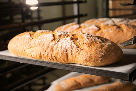 Loaves of bread on shelving in bakery