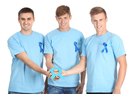 Young men holding blue paper ribbon on white background. Prostate cancer awareness conceptの写真素材