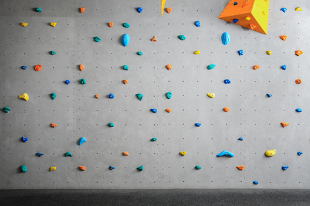 Grey wall with climbing holds in gymの写真素材