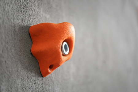 Climbing hold on grey wall, closeupの写真素材