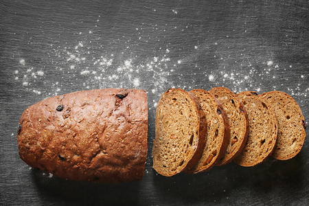 Yummy fresh bread on dark background