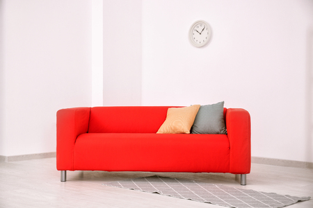 Comfortable red sofa in roomの写真素材