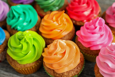 Tasty colorful cupcakes on tableの写真素材