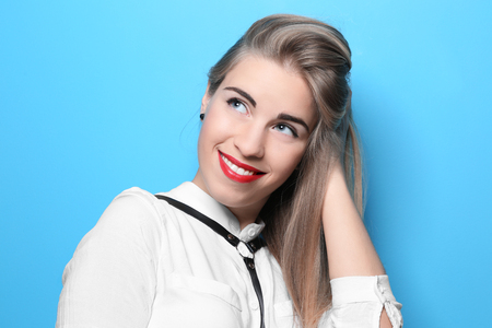 Young beautiful woman on color backgroundの写真素材