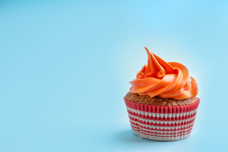 Tasty cupcake on color backgroundの写真素材