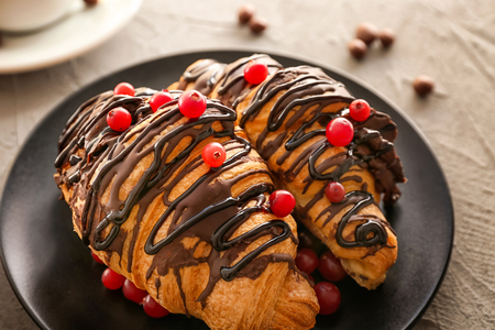 Plate with tasty croissants on table, closeupの写真素材