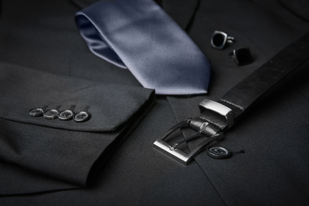 Elegant tie, cuff links and belt on male jacket, closeupの写真素材