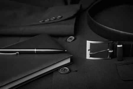 Elegant belt, notebook and pen on male jacket, closeupの写真素材