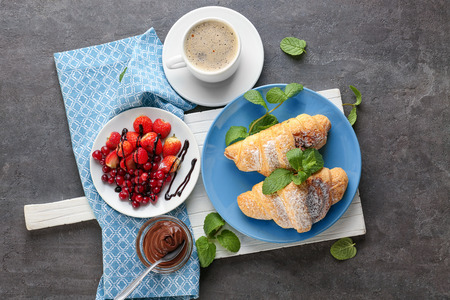 Composition with tasty croissants and fresh berries on tableの写真素材