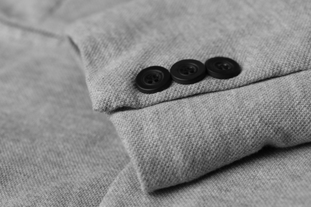 Buttons on elegant male suit, closeup