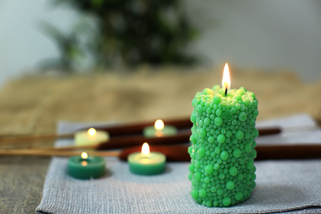 Burning color candle on blurred backgroundの写真素材