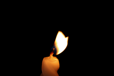 Wax candle burning in darkness, closeupの写真素材